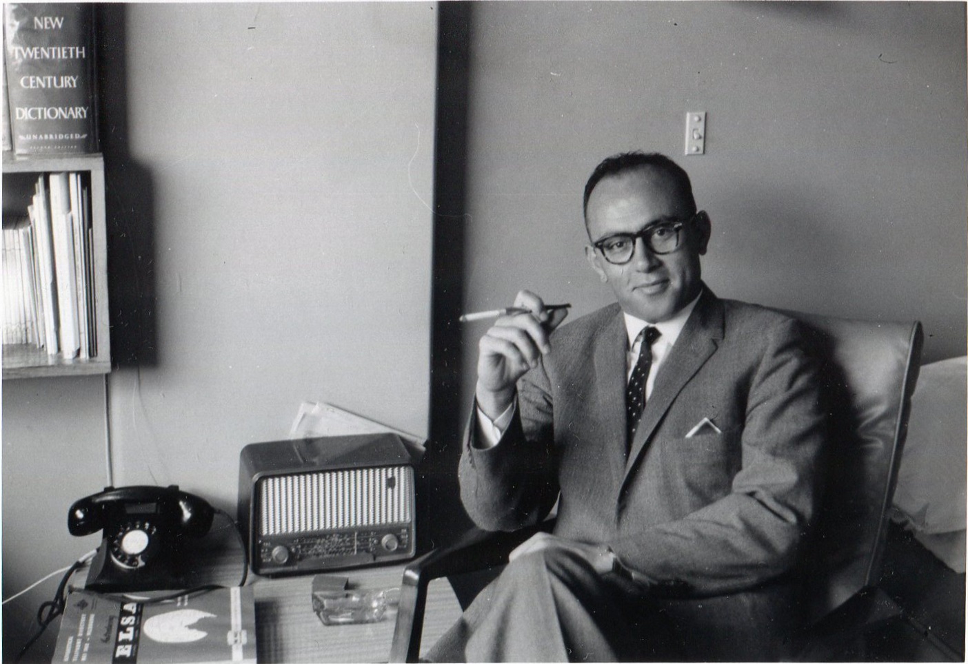 Black and white photograph of International House resident Nicos Kanaris seated and holding a cigarette.