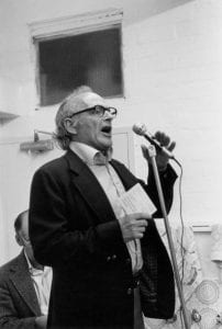 Black and white photograph of Bernie Taft speaking at a microphone