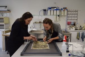Grimwade Senior Paper Conservator, Libby Melzer, with student conservator, Laura Daenke preparing the print for washing.