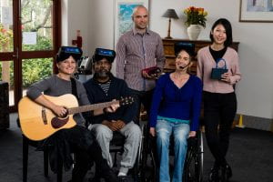 Group of music therapy researchers and participants wearing virtual reality headsets