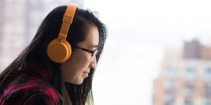 woman wearing headphones using a laptop computer