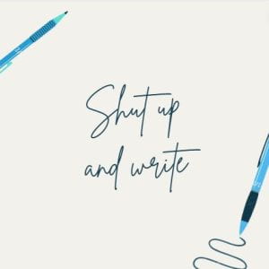 Two blue ballpoint pens with text "shut up and write" 